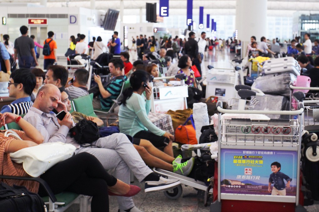 Passengers wait at Hong Kong International Airport in Chek Lap Kok at the height of the weekend's chaos. Photo: Dickson Lee/SCMP