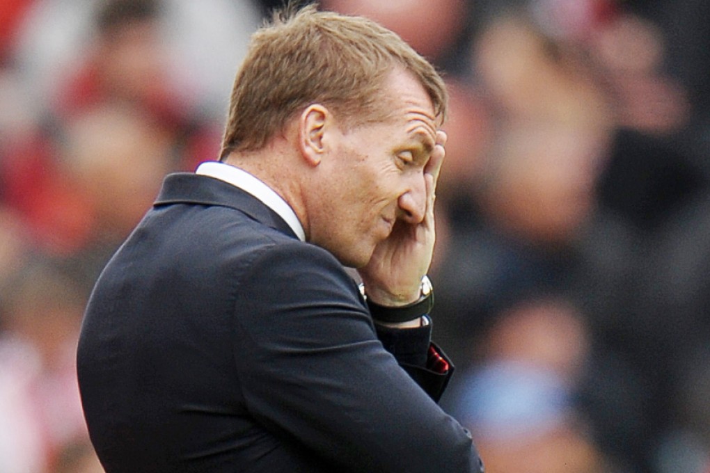 Liverpool manager Brendan Rogers can barely watch as his team capitulates 6-1 at Stoke. Photos: Reuters