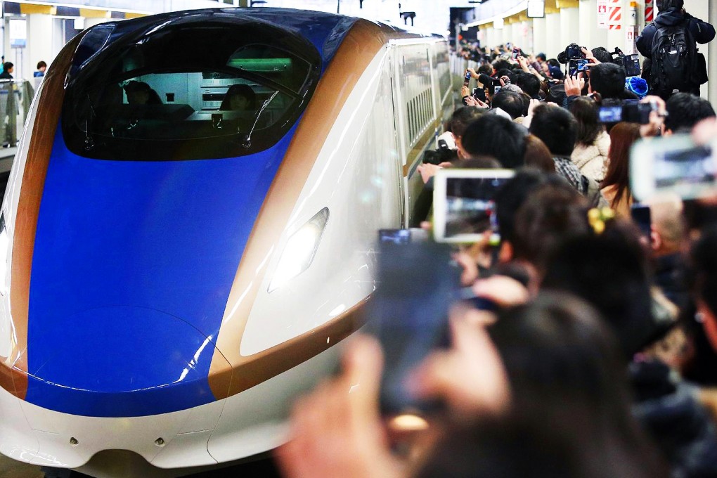 People await arrival of a shinkansen train. Photo: AFP