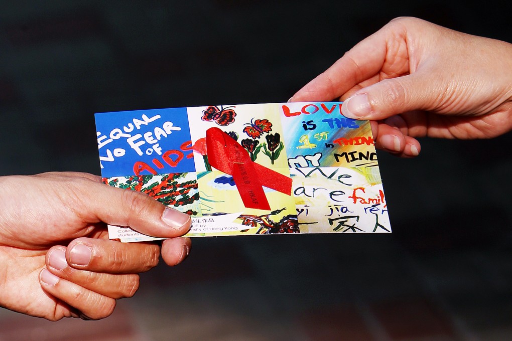 Members of Hong Kong AIDS Foundation hand out the red ribbons and leaflet to commemorate World Aids Day. Photo: Sam Tsang
