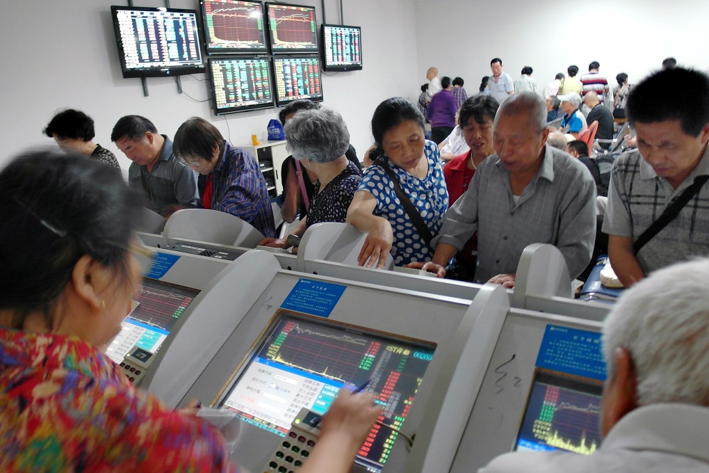 Investors pore over surging stock prices in China's Hubei province as equity markets in Hong Kong and Shanghai push to new highs. Photo: AP