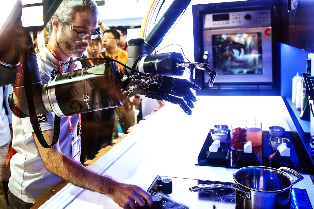 Moley Robotics' automated kitchen cooks for attendees at CES Asia in Shanghai. Photo: AFP