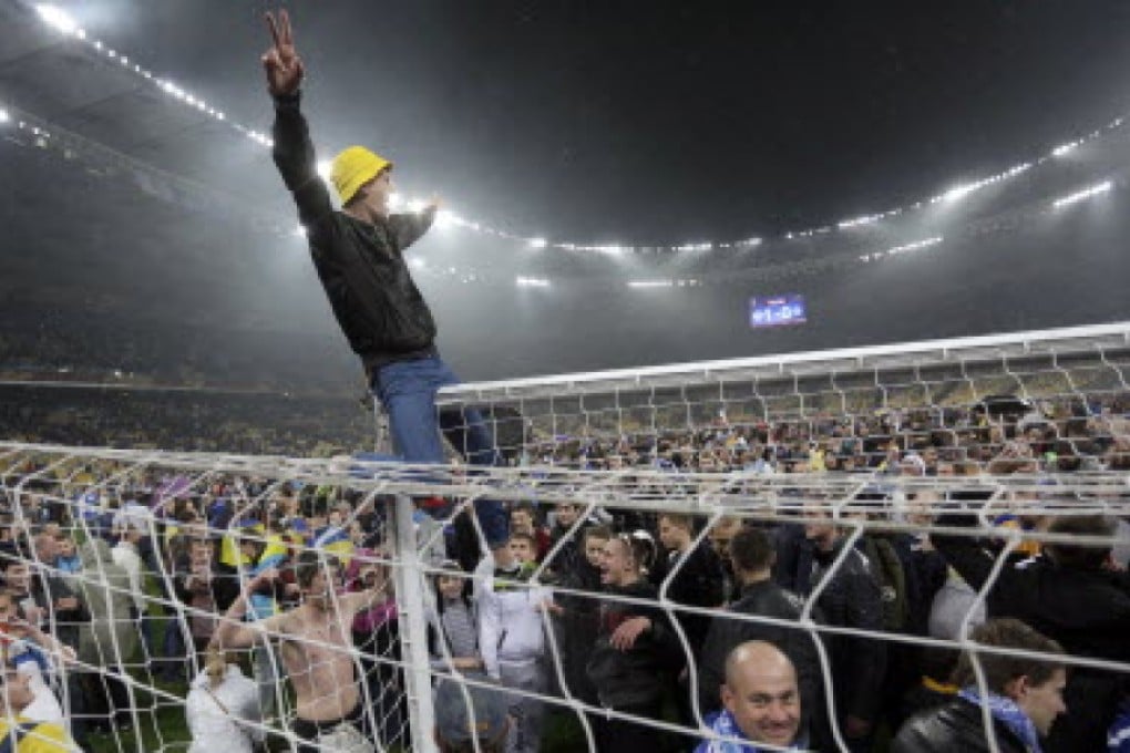 Dnipro fans celebrate after their team beat Napoli in the second leg of their semi-final in Kiev. Photo: AFP