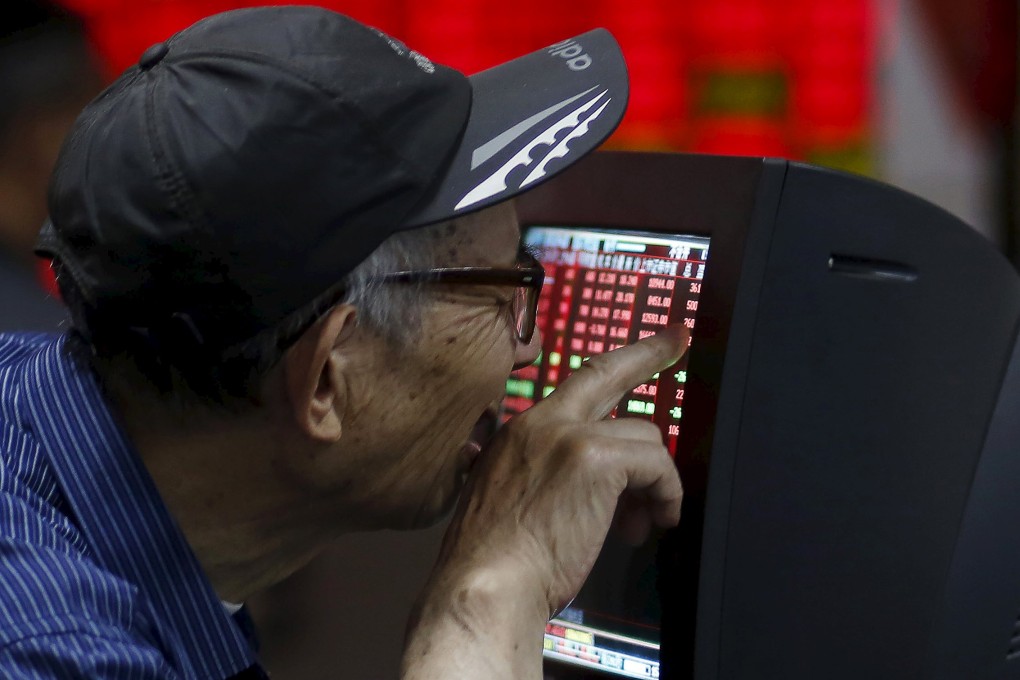 An investor checks the performance of his stock in Shanghai as the market continues its record-breaking run. Photo: Reuters