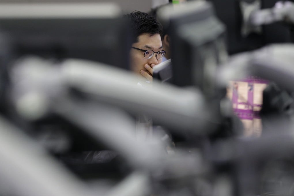 A currency trader in Asia keeps an eye on exchange rate as the market share of China currency in the global payment system increased to its highest level in four months. Photo: AP