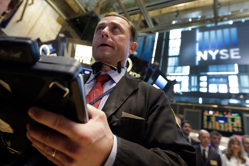 A dealer works the floor of the New York Stock Exchange as stocks climbed partly due to optimism a default by Greece will be avoided even though a deal is still being negotiated with its creditors. Photo: AP