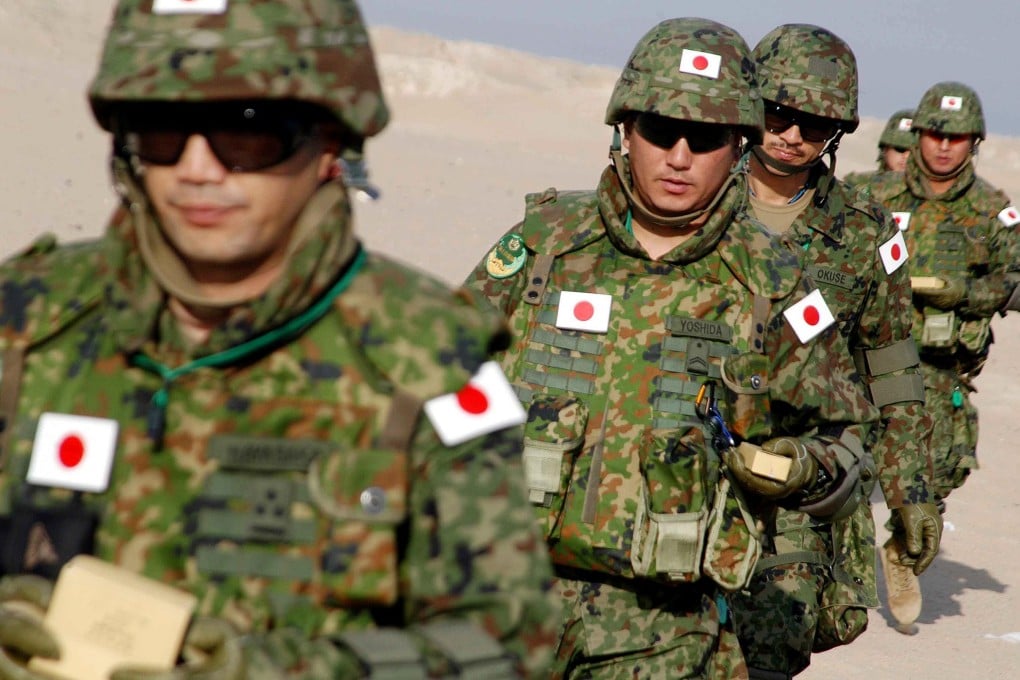 Soldiers from the Japanese Ground Self Defence Force take part in a drill at a desert in Northern Kuwait in 2004, in a preparation to join the Japanese contingent in Iraq. Photo: AFP