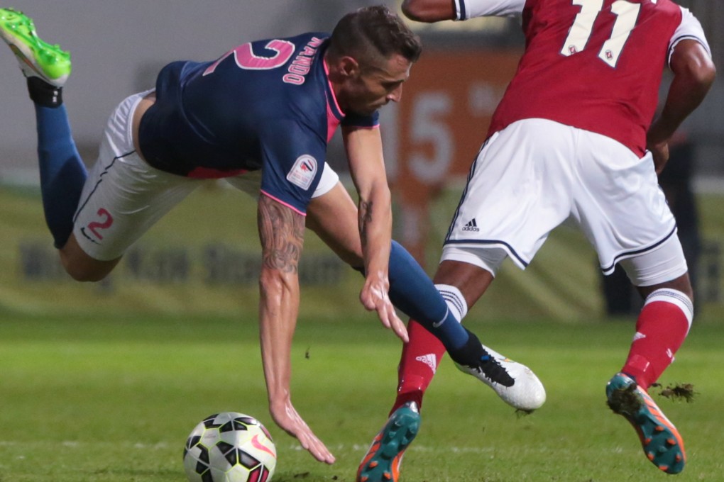 Kitchee Fernando Recio stumbles in a clash against South China's Nakamura Yuto during a Hong Kong Premier League match at Mong Kok Stadium. Photo: Felix Wong