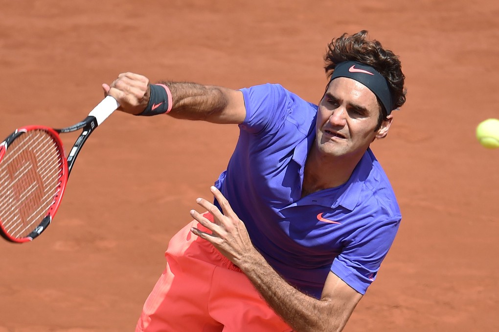 Roger Federer serves to Marcel Granollers in their second-round match. Photo: AFP