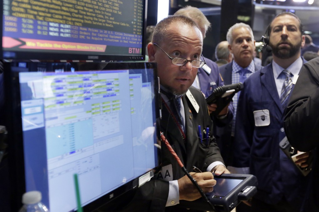 Traders on the New York Stock Exchange wait for news as markets in the US were only slightly lower on Thursday while keeping an eye on negotiations between Greece and its creditors. Photo: AP
