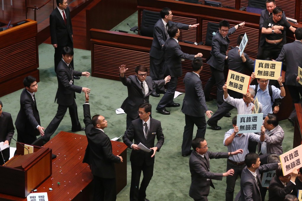 Words fly in the Legislative Council, then documents and a glass. Photo: K. Y. Cheng