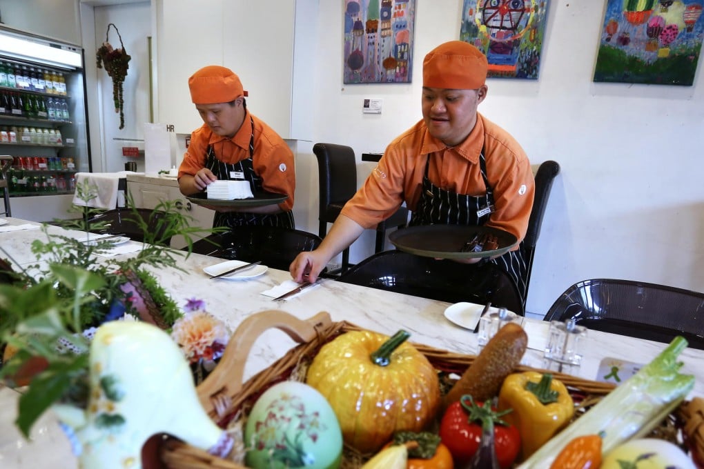Trainee Lo Kwok-wai (left) and cafe employee Tsui Man-leung work at iBakery Gallery Cafe at Tamar Park in Admiralty. Photo: Jonathan Wong