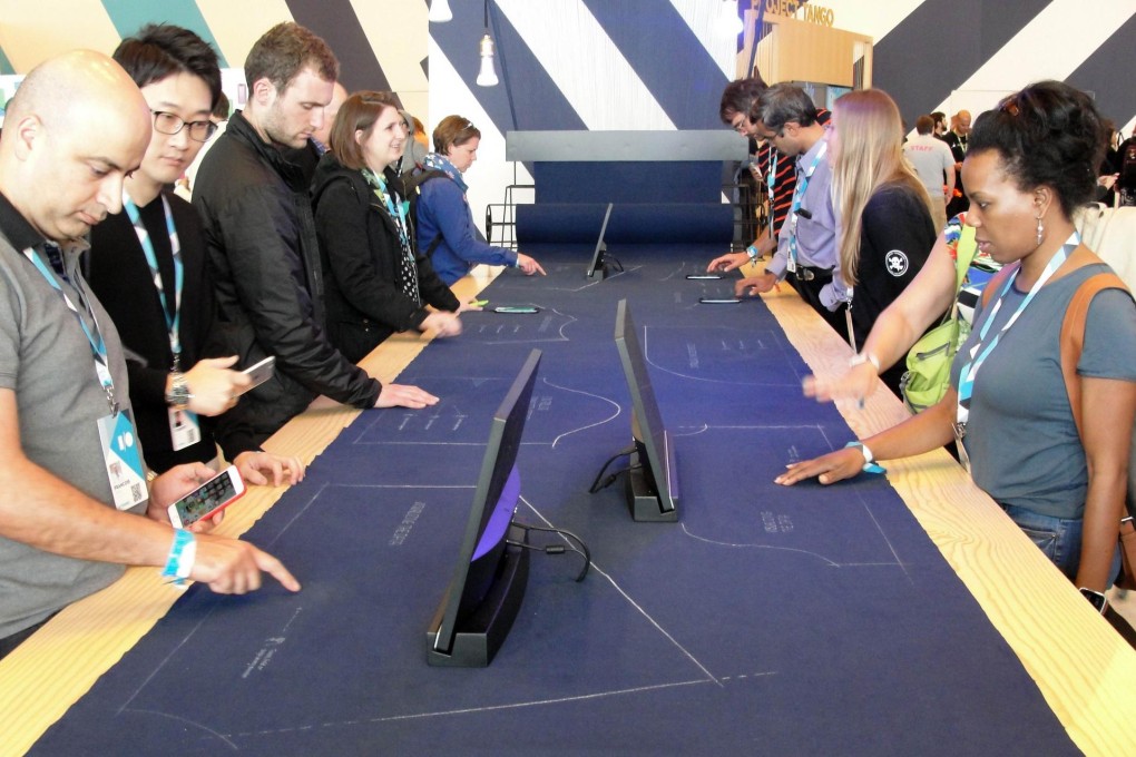 People touch the special Project Jacquard fabric.Photo: AFP