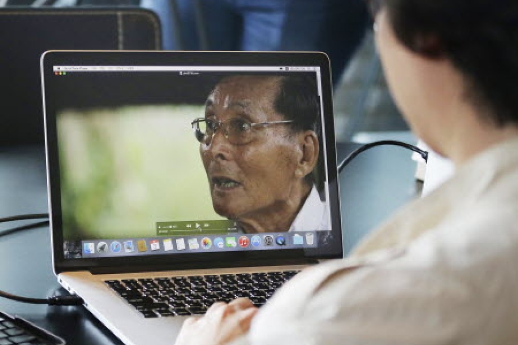 South Korean movie director Cho Kyeong-duk looks at a video showing Kim Myeong Bok, a former North Korean prisoner of war held in South Korea during the 1950-53 Korean War. Photo: AP