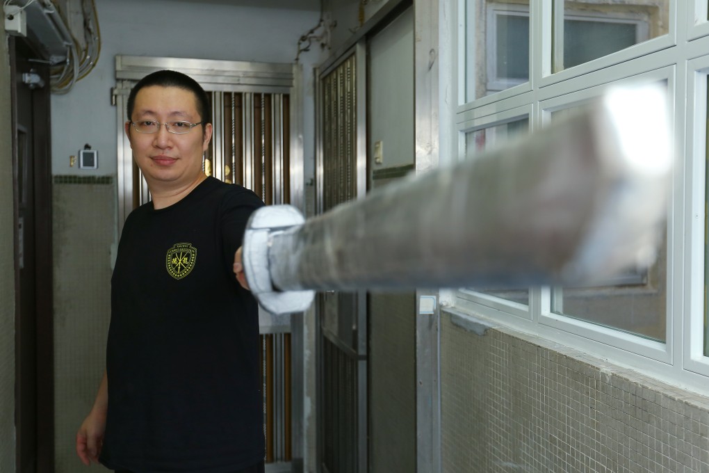 Lancelot Chan, a sword-fighting master in Hong Kong, poses with one of his replica weapons in Prince Edward. Photo: Edmond So