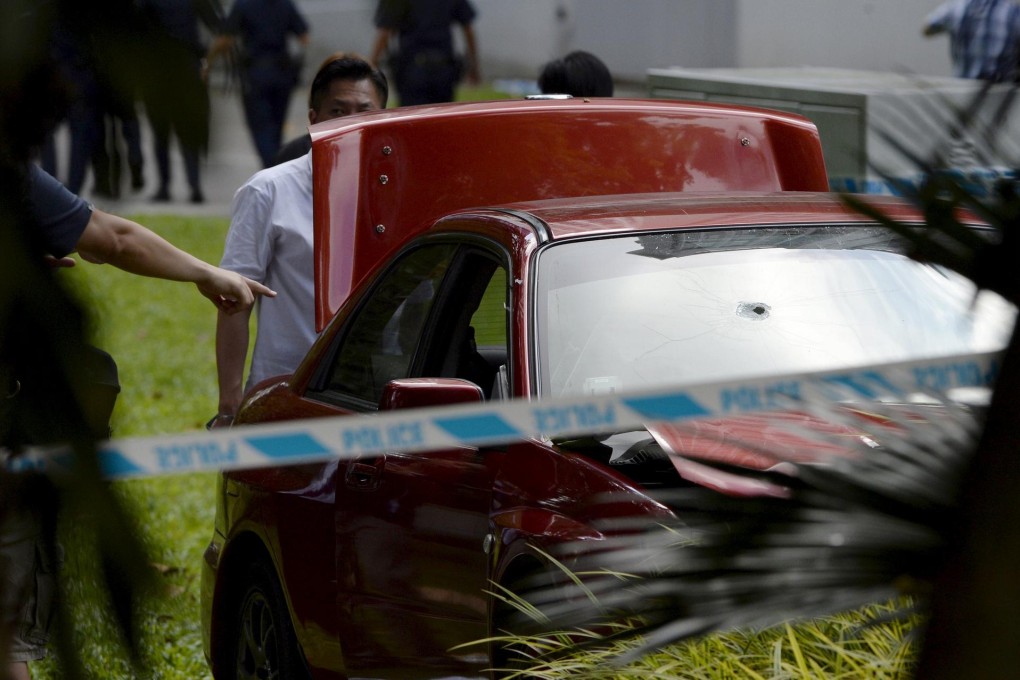 A bullet hole is seen in the front windscreen of the car which sped away from police near the Shangri-La Hotel in Singapore.Photo: Reuters
