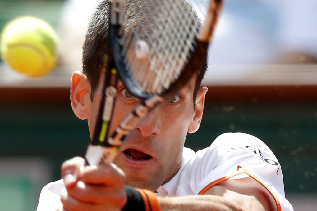 Serbia's Novak Djokovic returns the ball to Australian teen Thanasi Kokkinakis at Roland Garros during the French Open. Photo: AP