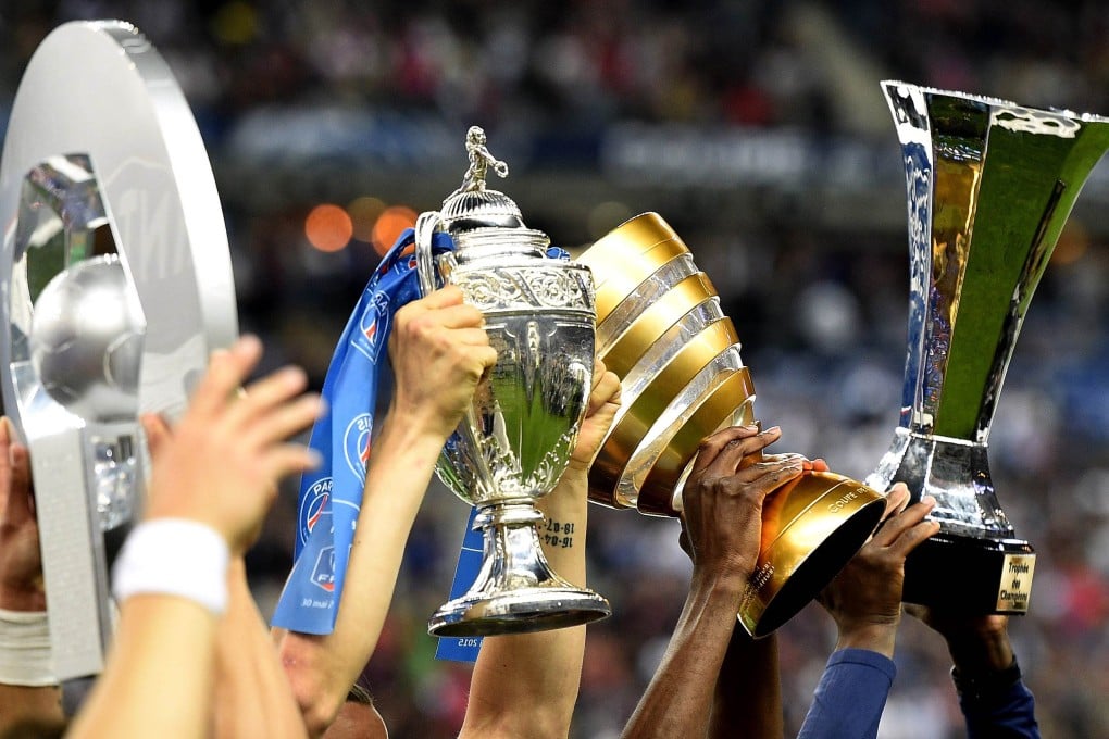 Thiago Silva holds the Ligue 1 trophy, Zlatan Ibrahimovic holds the French Cup, Blaise Matuidi holds the League Cup and Zoumana Camara holds the Champions' Trophy. Photo: AFP