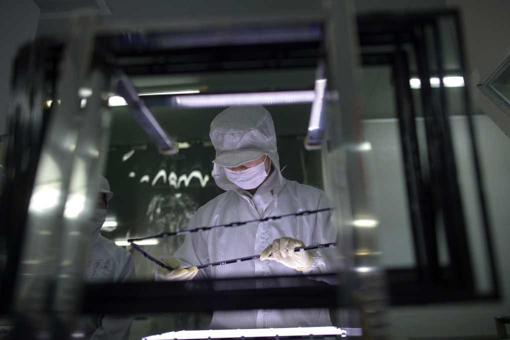 A factory worker handles an LCD screen. ASTRI and Truly have partnered to commercialise the former's research into LCD screens. Photo: Reuters