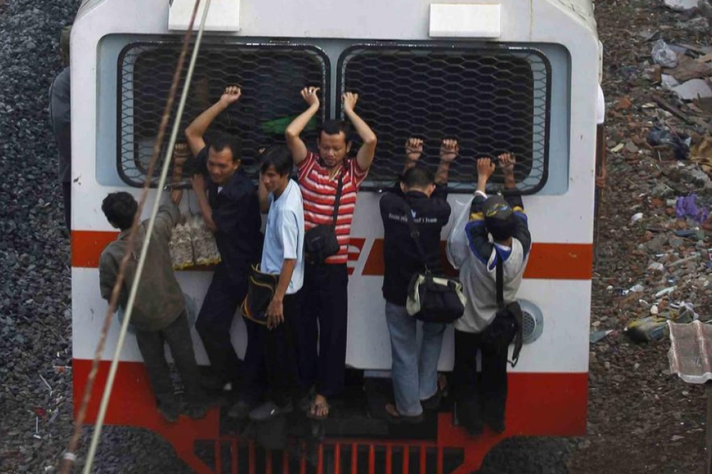 Commuters travel on a packed train in Indonesia. Photo: Reuters