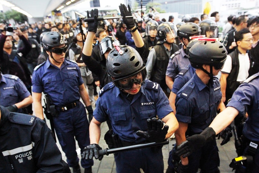 Riot police disperse protesters outside the Central Government Offices footbridge to Admiralty Centre on December 1, 2014. Photo: Edward Wong