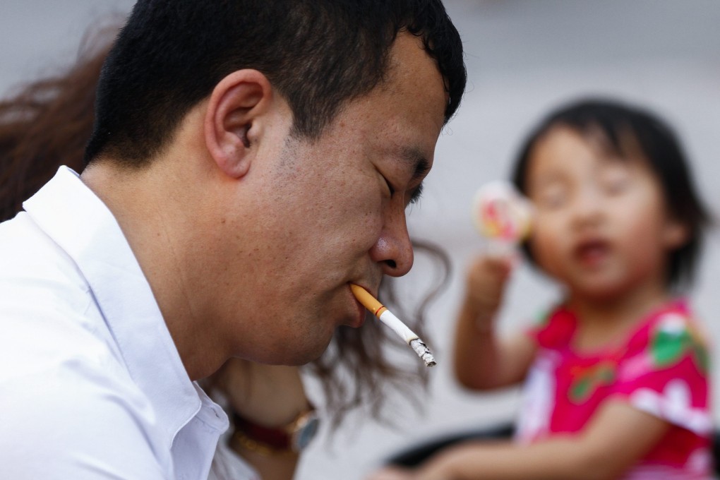 A man lights up in Beijing on Sunday, the day before the tougher anti-tobacco regulations were introduced. Photo: EPA