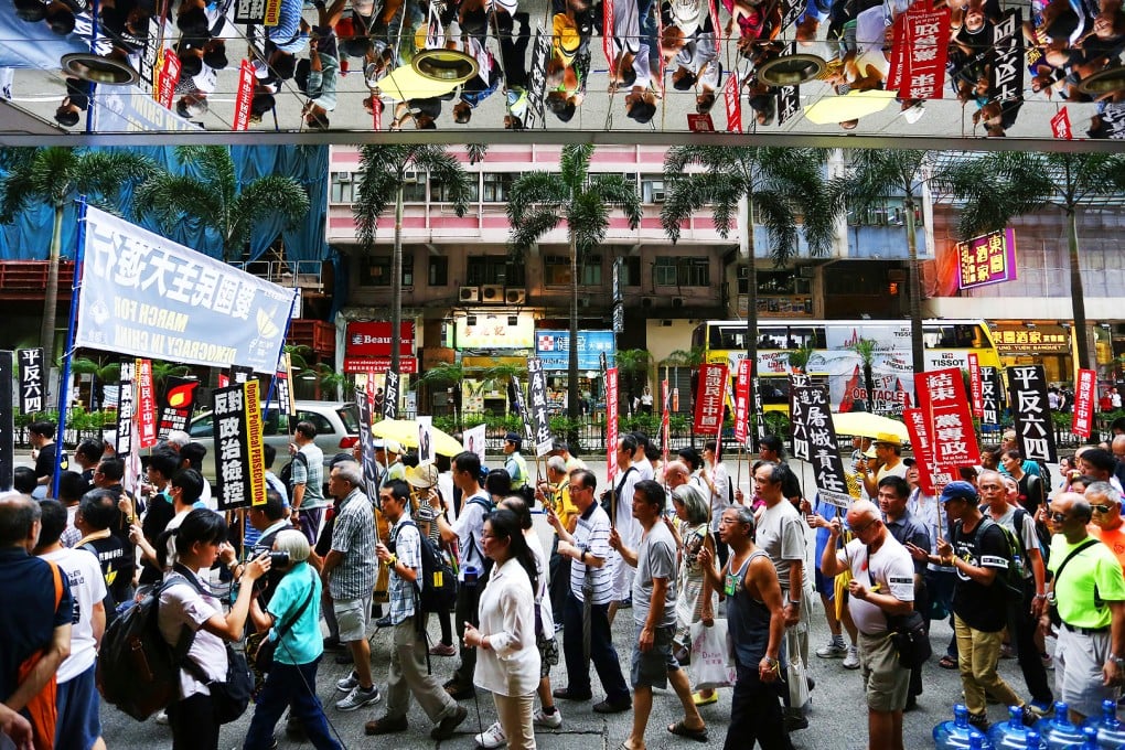 People marking the 1989 Tiananmen crackdown march to the central government's liaison office yesterday. Photo: Jonathan Wong