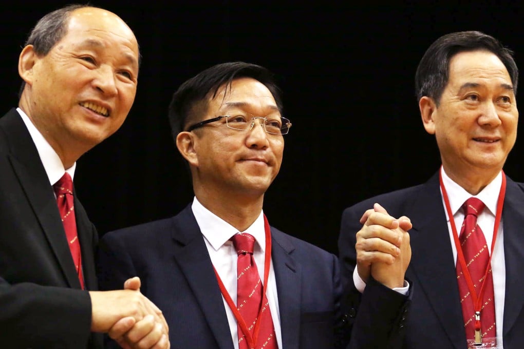 Cheung Hok-ming (left) and Daniel Lam Wai-keung congratulate new chairman Kenneth Lau. Photo: Felix Wong