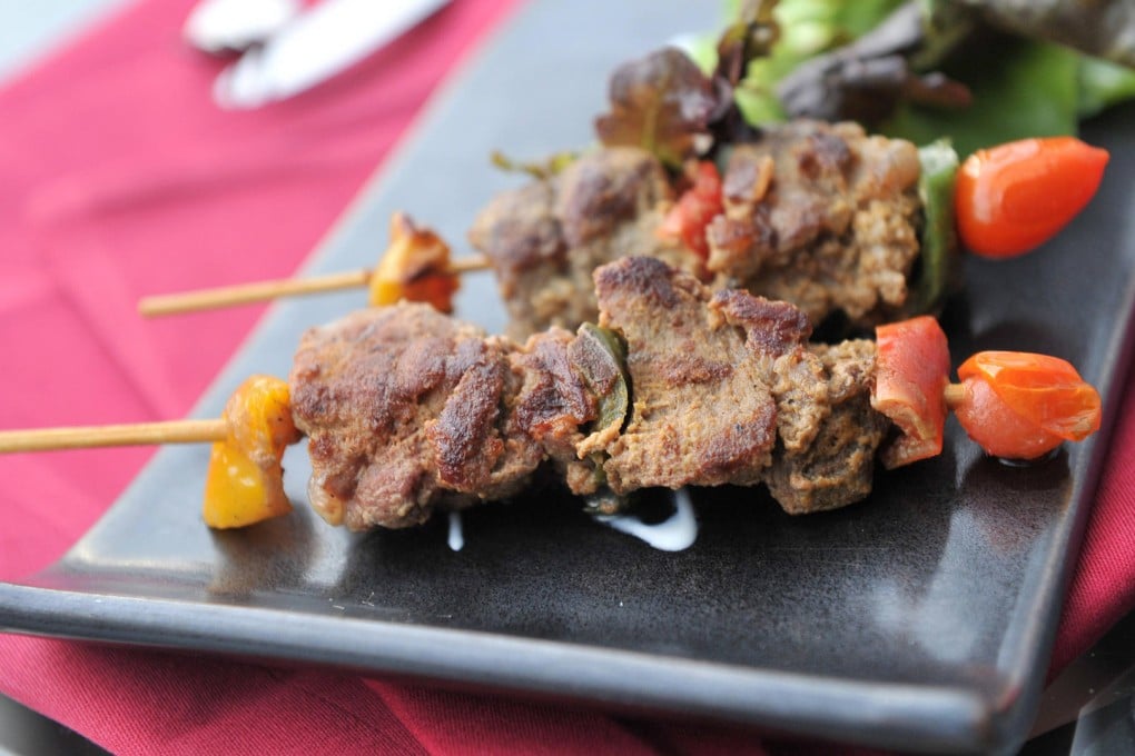 Thai street food: grilled chicken innards in Bangkok