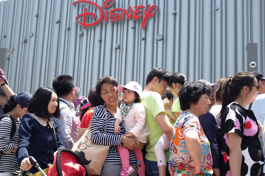 People queue to enter mainland China's first Disney store, and the world's largest, at the Pudong financial district in Shanghai. Photo: Reuters