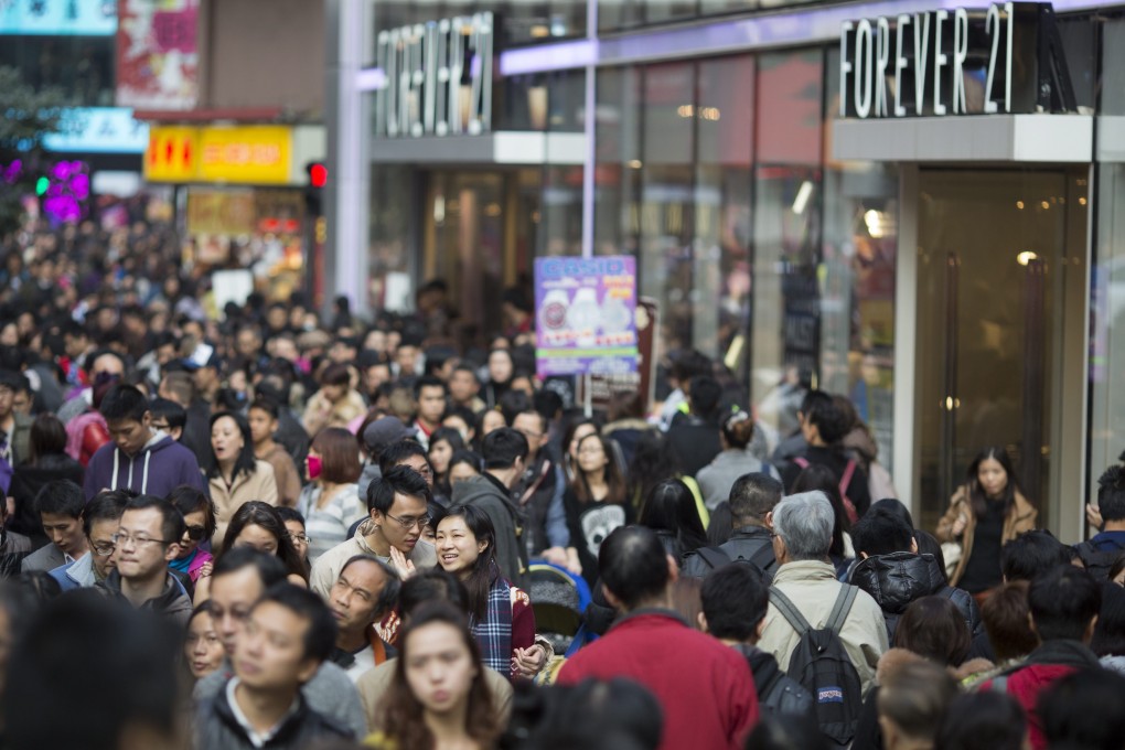 A bustling shopping street in Hong Kong. City residents have not taken to e-commerce with the same gusto. Photo: EPA