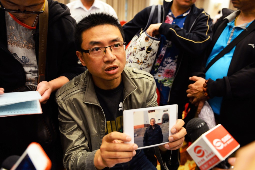 A man shows a photo of his father-in-law, who was on board the Eastern Star. Photo: TNS