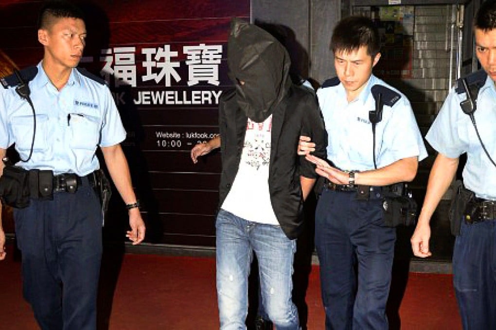 Tong Mong-leong, pictured here with his face covered when he was arrested last year, pleaded guilty. Photo: SCMP Pictures