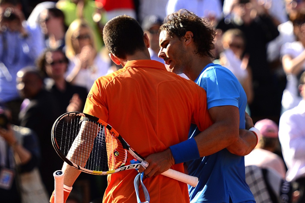 Novak Djokovic of Serbia hugs Rafael Nadal after beating the "King of Clay" in straight sets in their quarter-final match at Roland Garros.  Photo: EPA