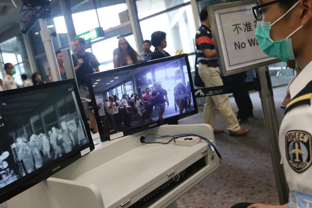 Passengers flying in from Busan in South Korea receive temperature checks for Mers at Chek Lap Kok airport. Photo: David Wong