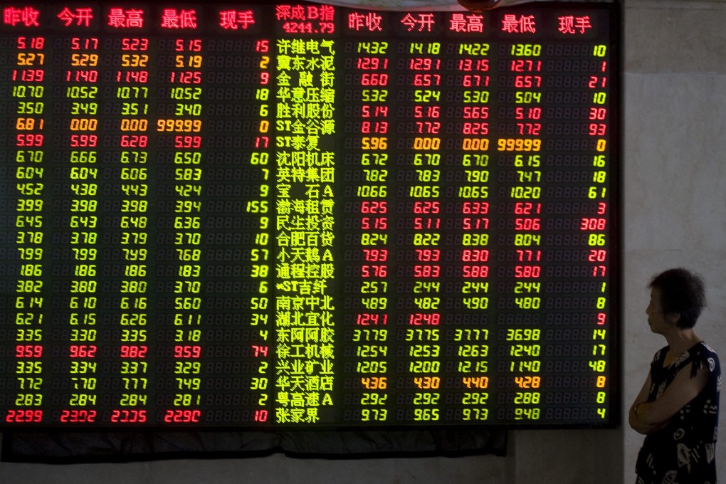 An investor stands in the shadows as the Shanghai market in China soars to a fresh 7-year high. Photo: EPA