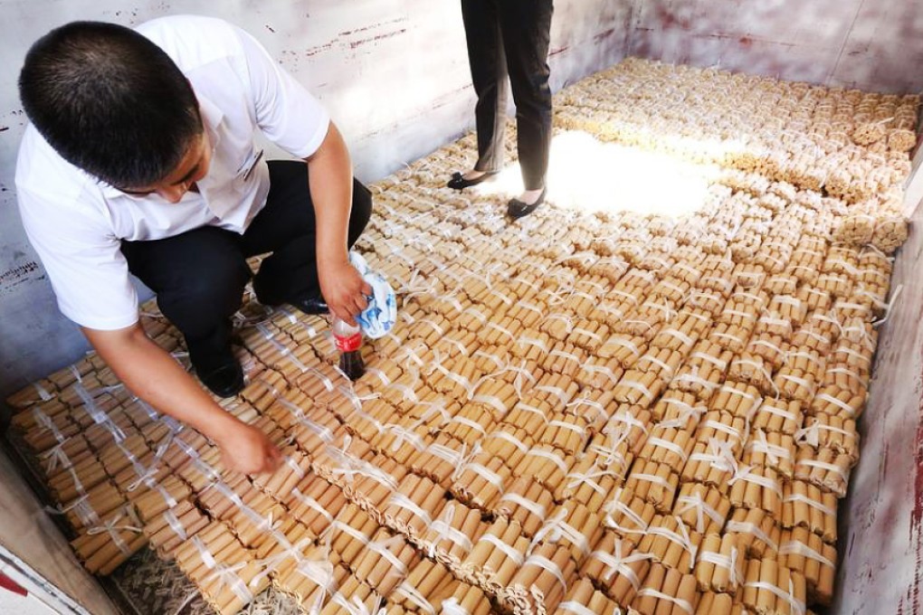 More than 600,000 worth of coins are kept in a makeshift storehouse in a car dealership after a customer bought a SUV with 680,000 yuan in cash in Northeastern Liaoning province. Photo: Xinhua