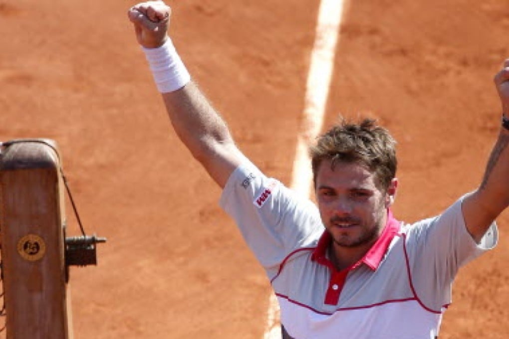 Stan Wawrinka raises his arms in triumph after beating Jo-Wilfried Tsonga in the French Open semi-finals. Photos: EPA