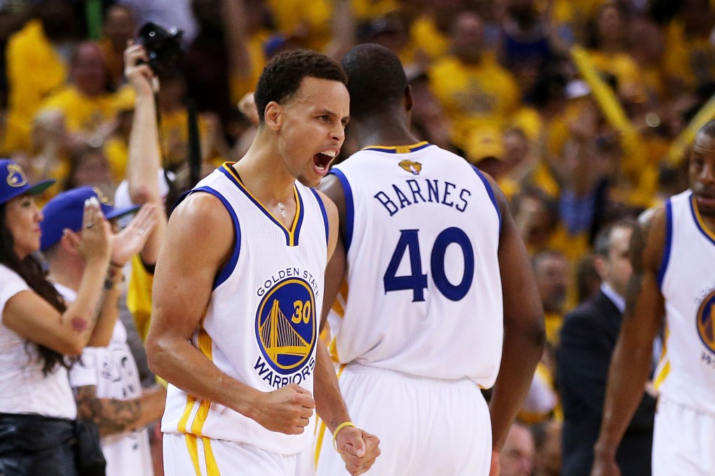 Stephen Curry urges on his teammates with the game in extra time. Photo: AFP