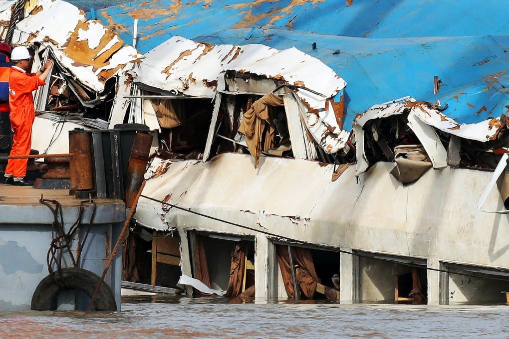 Hoists lift the capsized cruise ship in the Yangtze River. Photo: Reuters