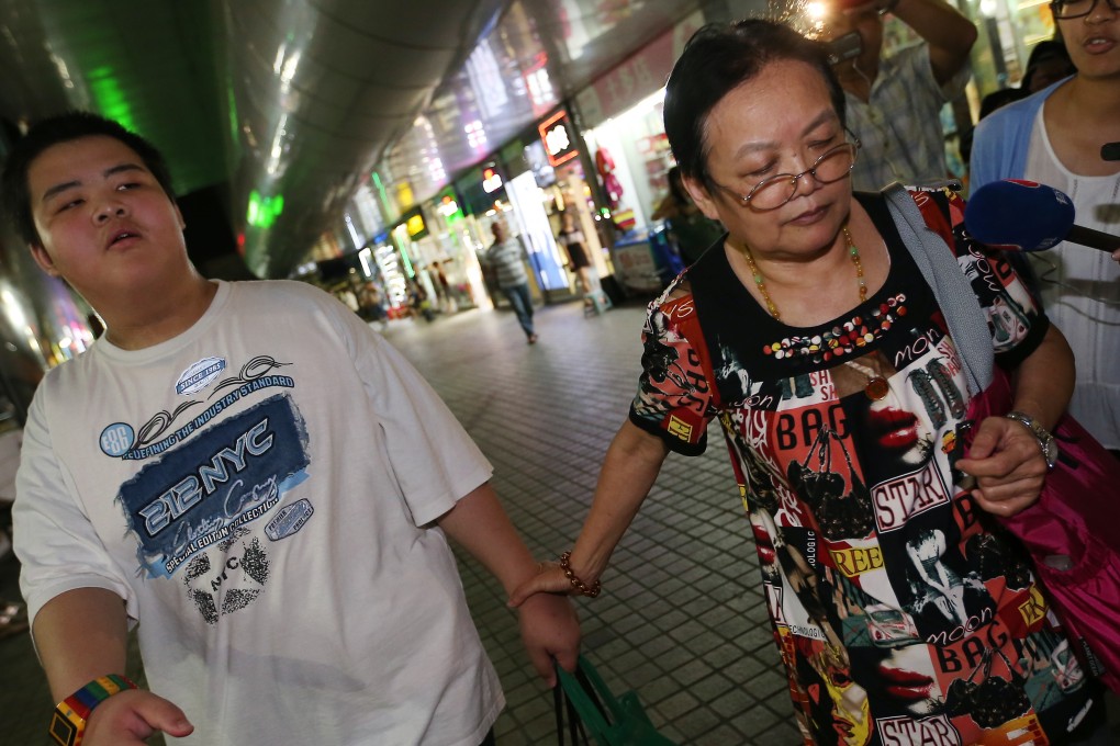 12-year-old boy Siu Yau-wai and his grandmother Chow Siu-shuen on their way to Shenzhen after seeking voluntary repatriation. Photo: K.Y.Cheng