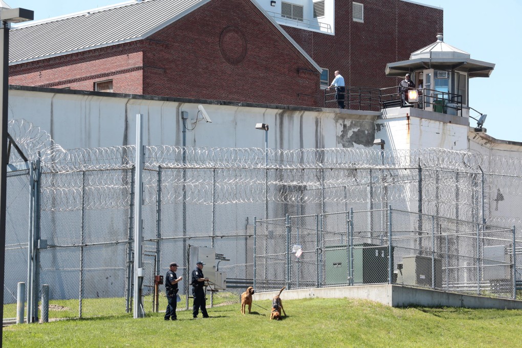 Law enforcement officers with bloodhounds stand guard at an entrance to the Clinton Correctional Facility in Dannemora, New York. Photo: AP