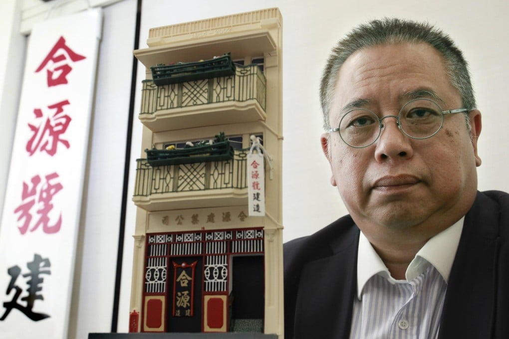 David Tse is unhappy that a cigar shop's signboard now blocks the historic signage of his family's building materials company at 18 Ship Street. Photo: Dickson Lee