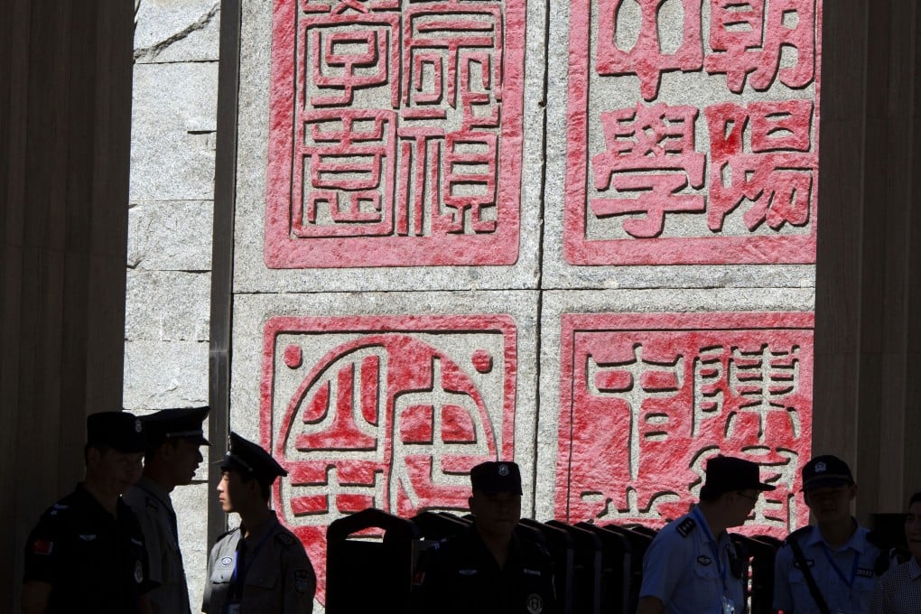 Security personnel guard the entrance to one of the schools where the annual Gao Kao or national college entrace exams are being held in Beijing. photo: AP Photo