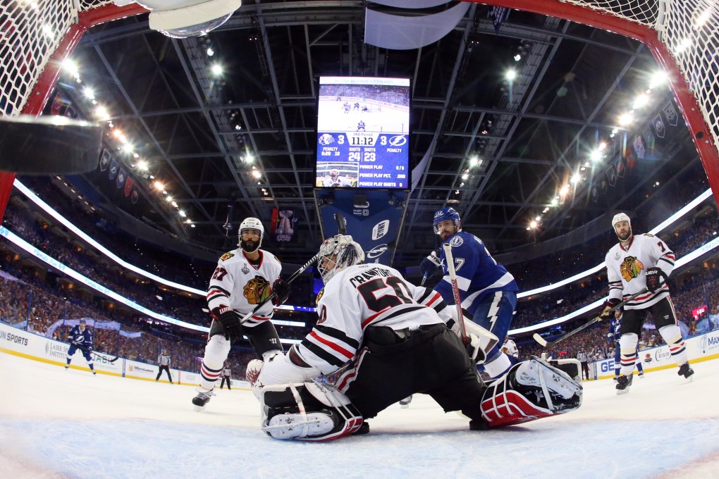 Blackhawks goalie Corey Crawford gives up a goal to  Lightning defenceman Jason Garrison. Photo USA Today