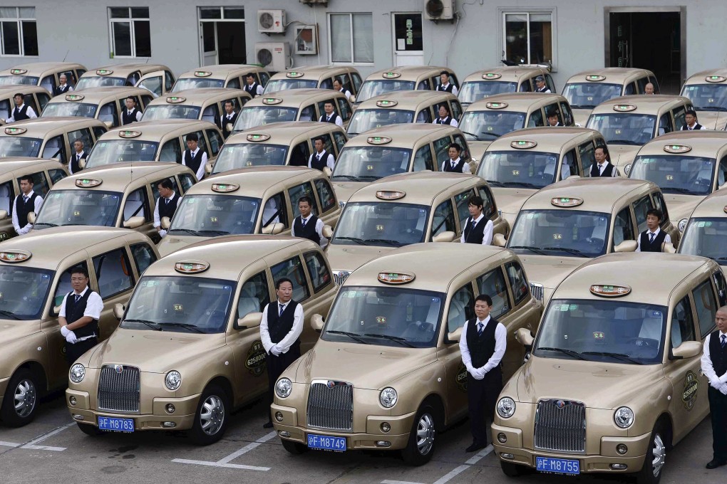 Shanghai taxi drivers stand next to their vehicles. Uber, Didi Kuaidi and other taxi-hailing apps have revolutionised the industry in China. Photo: Reuters