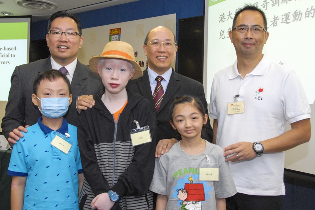 Young cancer survivors (front left to right) Luo Hong-bin, nine, Ryan Chan, 14, and Vanessa Law, nine, with Dr William Li (far left).
