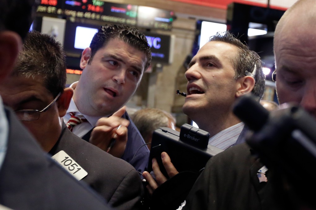 Traders on Wall Street huddle after release of the monthly US jobs report on Friday as the market looked ahead to a possible rise in interest rates in September. Photo: AP