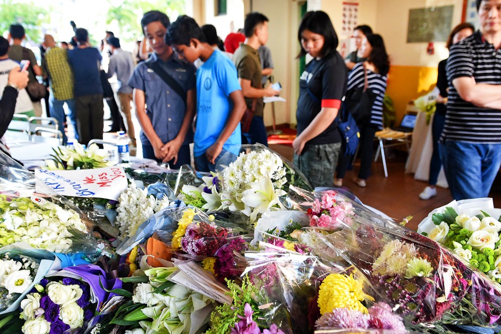 Bouquets of flowers and messages in memory of the victims from an earthquake on Malaysia's Mount Kinabalu. Photo: AFP