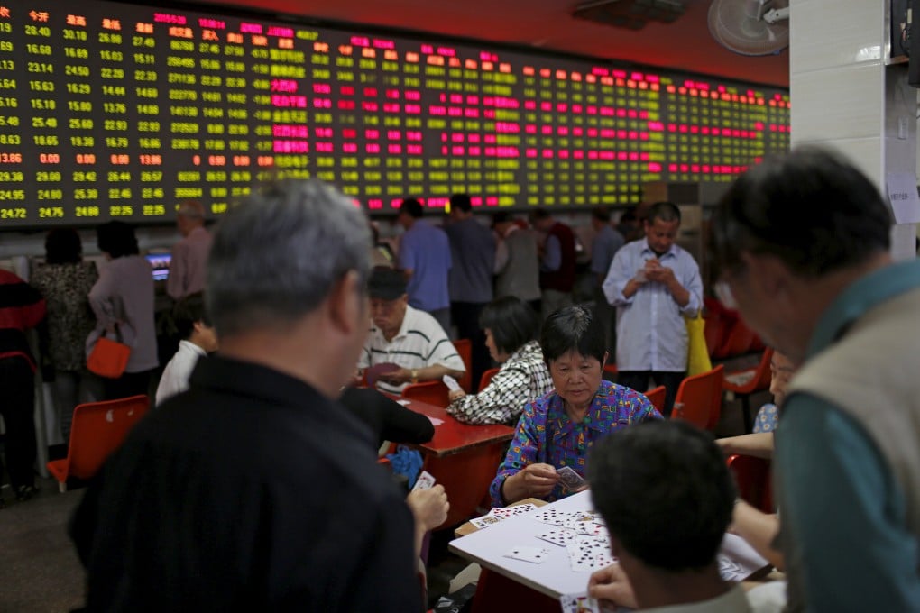Chinese investors huddle in Shanghai as big players speculate on the next major move in the country's equities which many feel would be a sharp decline in the days or weeks ahead. Photo: Reuters